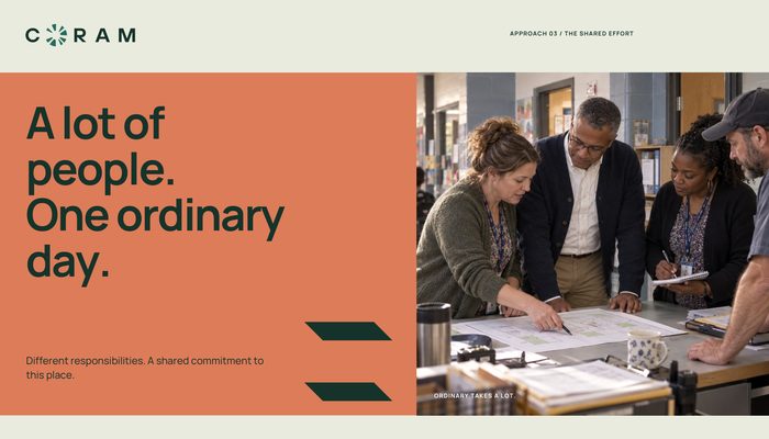 The Shared Effort campaign composition on coral: A lot of people. One ordinary day. Different responsibilities. A shared commitment to this place. Four staff members work over plans at a table beside a pair of tapered strokes.