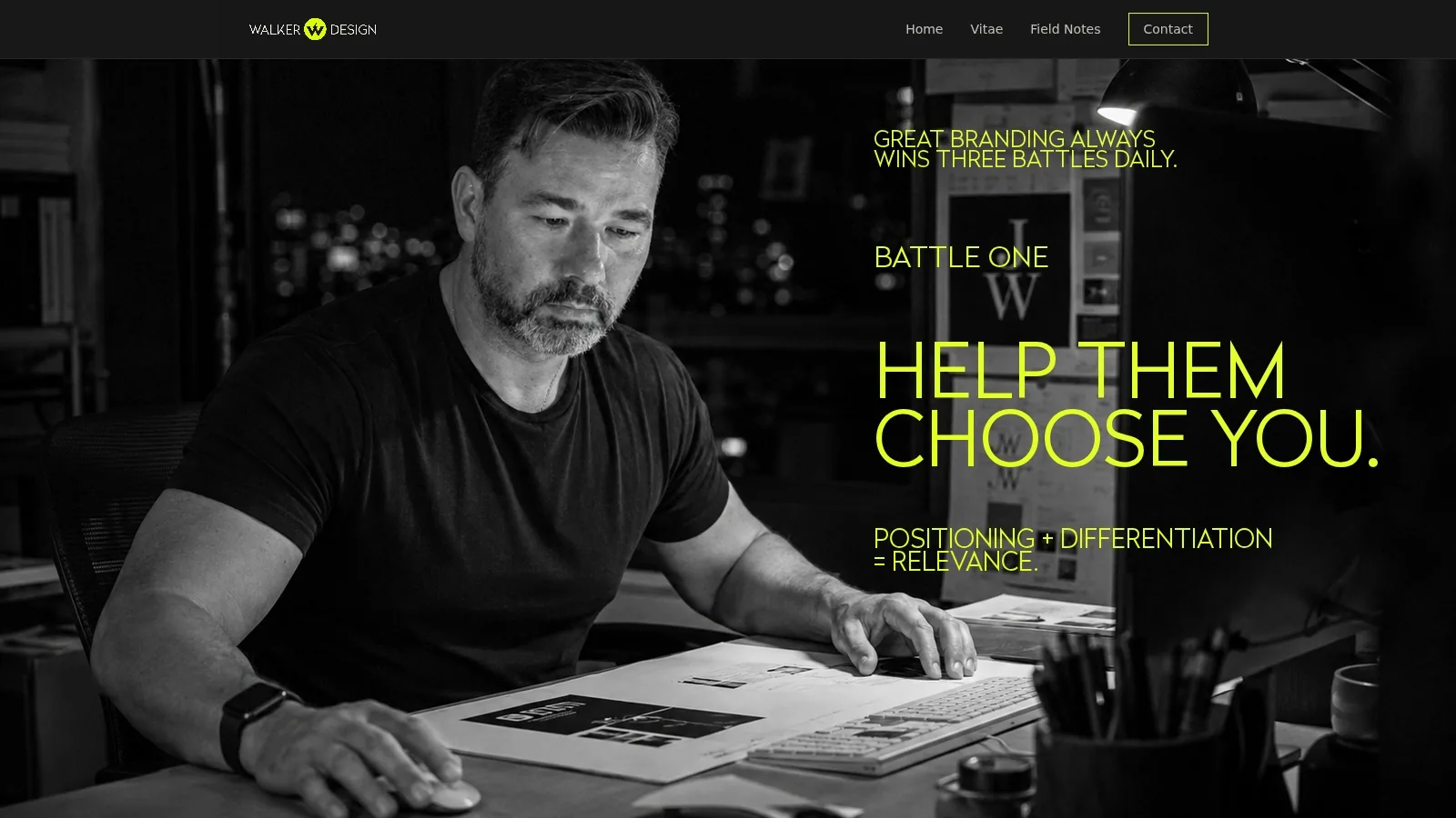 Jason Walker working at a desk at night, a brand identity on the table, in black and white.