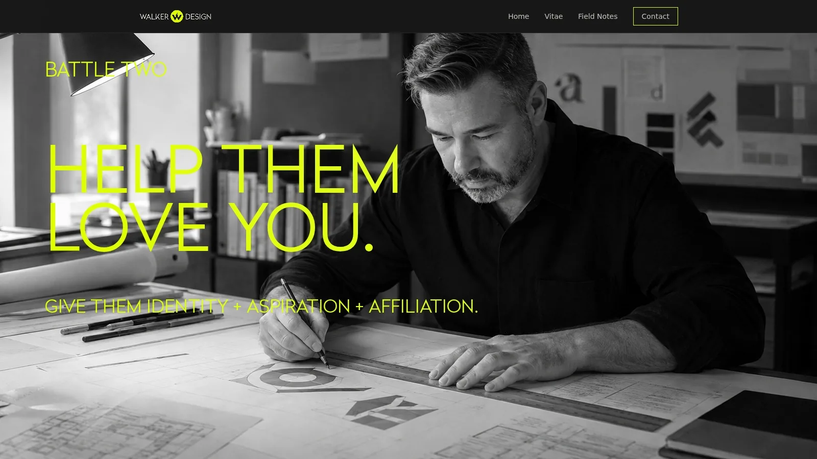Jason Walker drawing an identity by hand at a drafting table, in black and white.