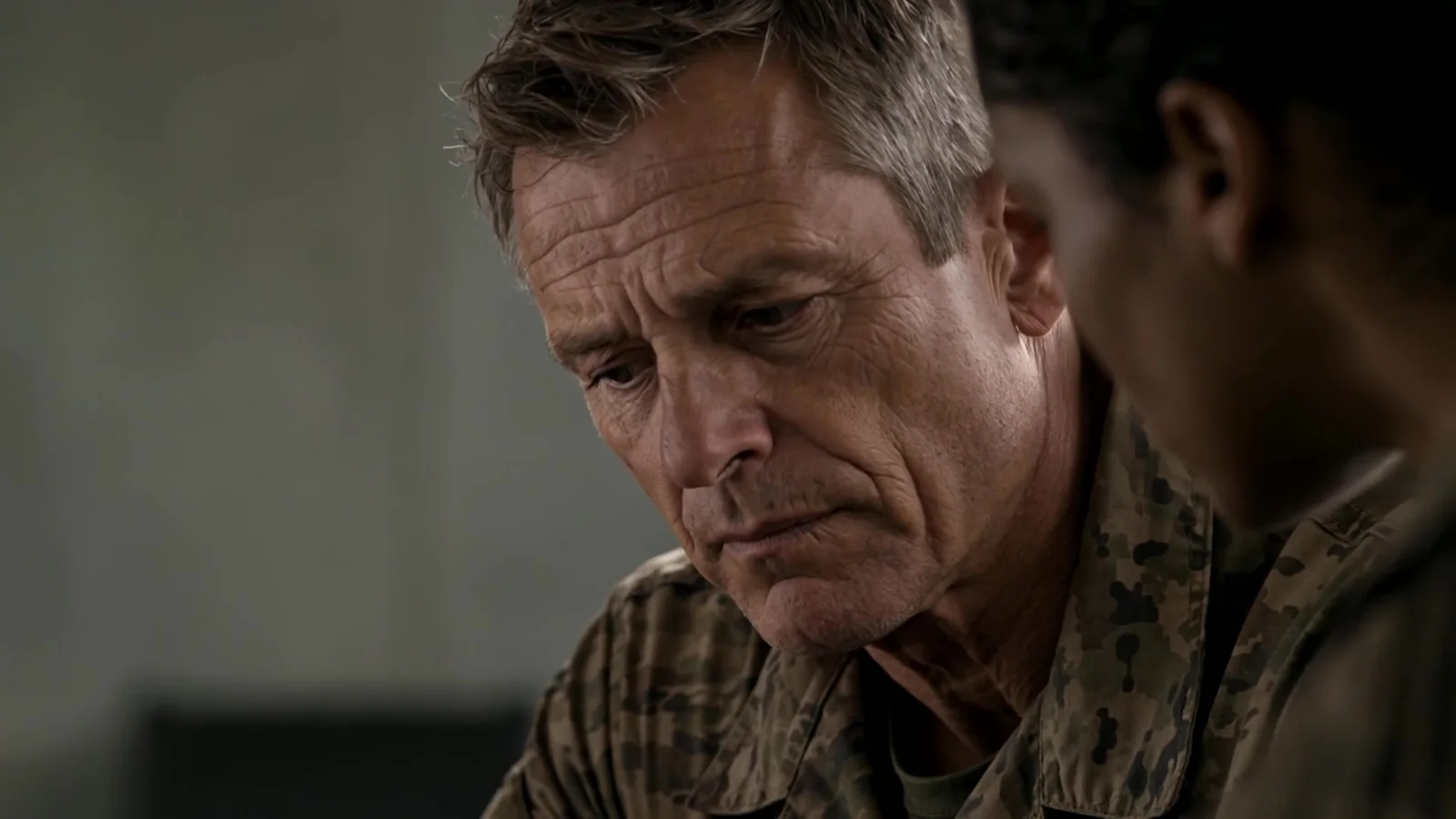 A senior officer studies a screen before a decision. A frame from One Shared Now; a generated scene.