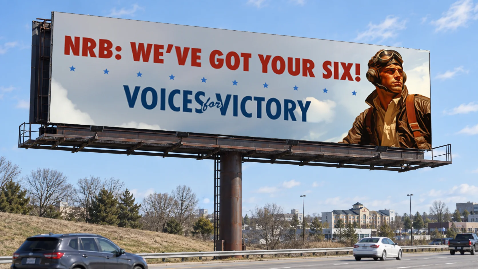 Roadside billboard carrying the 2024 design “NRB: We’ve Got Your Six!”: a pilot against open sky