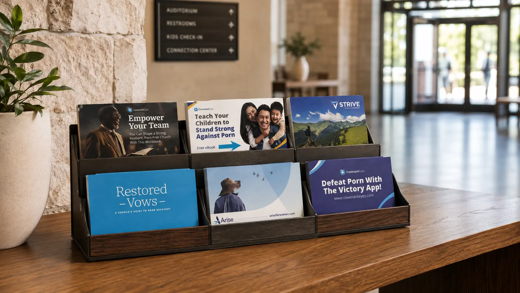 A rack of 5 Stones resource cards in a church vestibule.